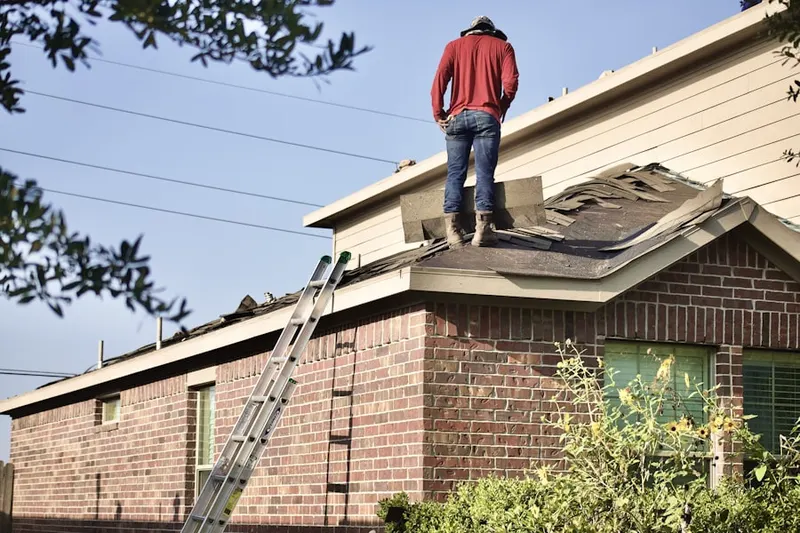 Professional roofer working on a residential roof in Dyes Oakcrest